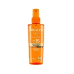 بطری نارنجی رنگ اسپری روغن برنزه کننده بیوکسین SPF 15 حاوی عصاره هویج در فروشگاه هموفا